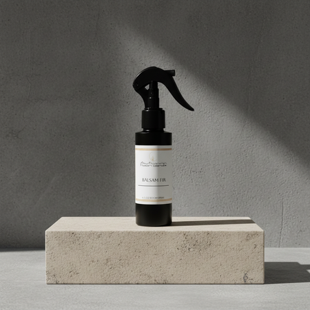 Autumn Moon Candle Balsam Fir 4oz Room Spray pictured on a concrete block