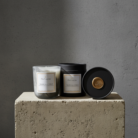 Autumn Moon Candle Tropical Citrus black glass jar candle with black box sitting on a stone pedestal